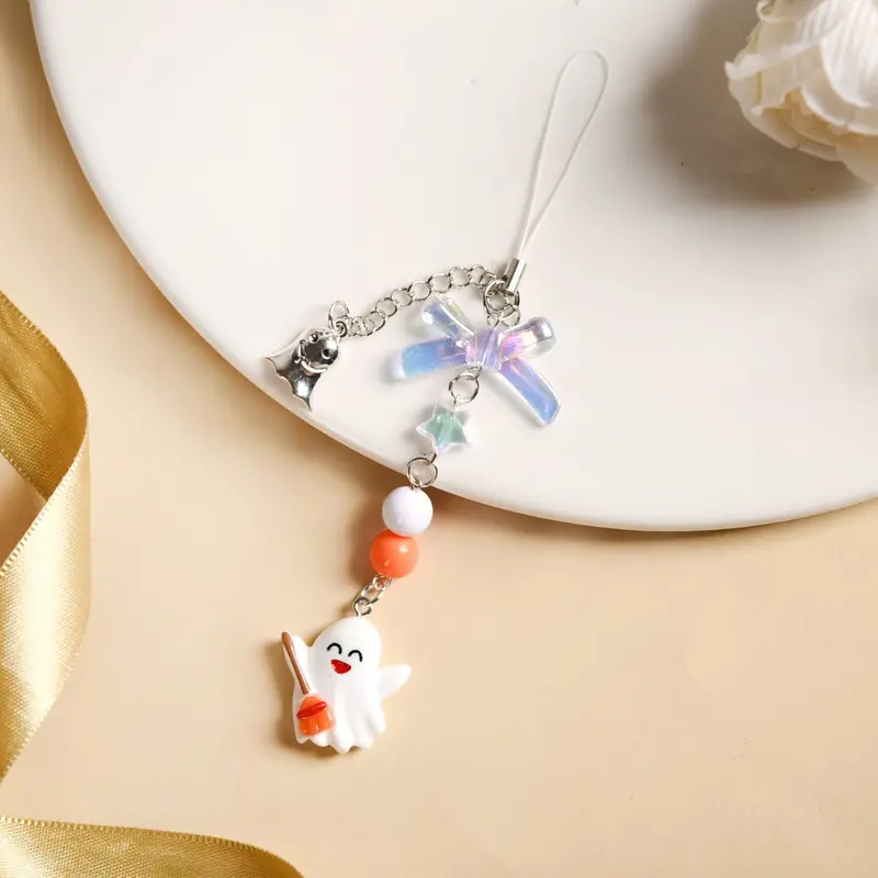 Playful Baby Ghost On Broomstick Phone Strap 1
